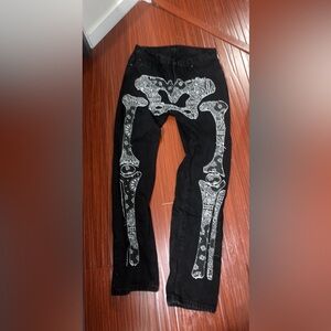 Black loose jeans with a stitched bandana skeleton pattern